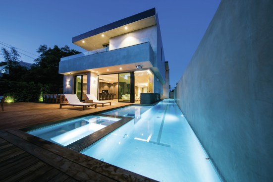The home's outdoor portion includes a heated two-lane lap pool.