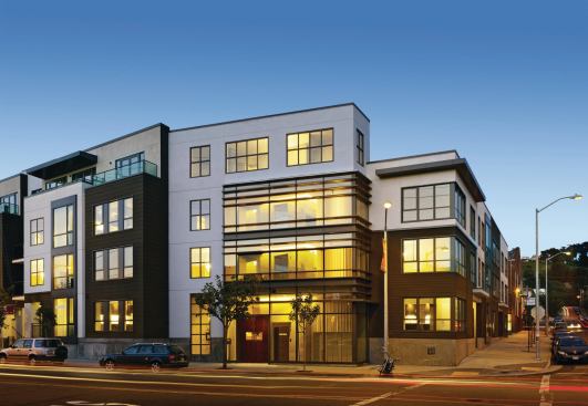 Originally this site held two disparate elements: a historic but crumbling brick warehouse and a 40-foot-deep hole leftover from a previous commercial project that fell through. The resolution, which combines adaptive reuse and new construction to create 76 attached residences (a blend of two-story townhomes and flats) is a perfect marriage of old and new. “Rather than doing something overly referential or historicist with the new building, we designed it for contrast,” explains architect Scott Lee. Offsetting the warehouse’s old brick, the new structure uses a modern vocabulary of horizontal wood siding, stucco, steel, and glass. 
Project: Union, San Francisco 
Architect: SB Architects 
Builder: Taisei Construction Corp. 
Developer: Palisades Development Group