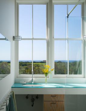 Not a bad spot to stand and brush your teeth, eh? Even the second floor master bath in this coastal New England home enjoys panoramic views of the Atlantic. 
Architect: Estes/Twombly Architects, Newport, R.I. 
Builder: Highland Builders, Tiverton, R.I.
