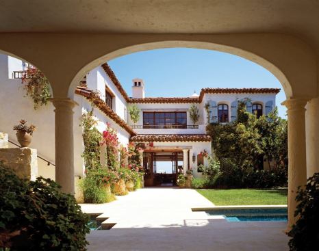 This beachfront villa certainly takes its fill of sand and sea, but its architecture provides some nice eye candy, too. Features such as natural stone walls, filigreed iron railings, and climbing bougainvillea give the home a graceful presence. The arched colonnades and portals that appear at every turn form intimate frames for those details. 
Architect: Landry Design Group, Los Angeles 
Builder: Albino Construction, Culver City, Calif.