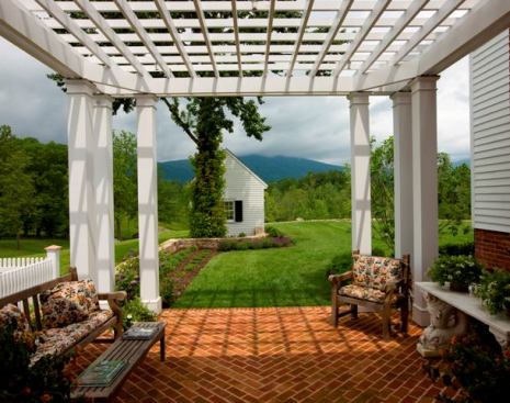 A patio trellis frames panoramic views of the Blue Ridge Mountains in this restored antebellum farm dating back to 1829. 
Architect: Mark P. Finlay Architects, Southport, Conn. 
Builder: Gibson/Magerfield Corp., Charlottesville
