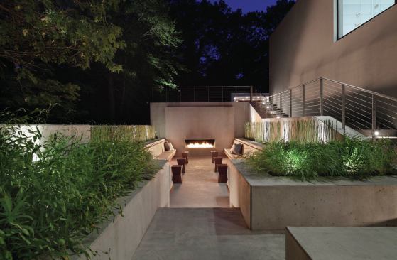 A cast-in-place fireplace welcomes guests at night.