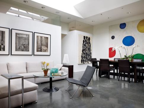 A large skylight makes the living area feel like a courtyard, and clerestories brighten the master suite behind it. A shade inside the skylight protects the owners’ artwork from direct sun.