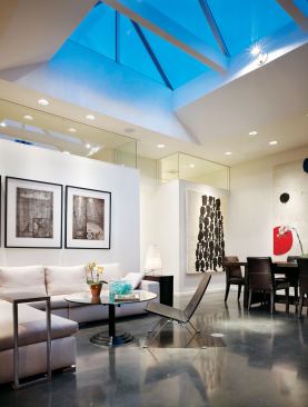 The airy living and dining room at the house’s center features a 12-foot-9-inch-by-9-foot skylight.