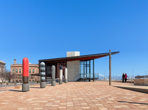 The public art requirement is met by a series of five 'dungos' created by ceramic artist Jun Kaneko. Architect Paul Mankins selected the pieces from Kaneko's stock that he felt were  most appropriate for the space and positioned them in a way to occupy the plaza. "We chose neutral colors except one with a vermillion segment that pickups steel in pavilion and adjacent pedestrian bridge," he says. 