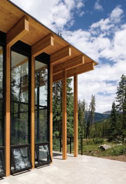 Exposed timber columns echo the surrounding lodgepole pines.



