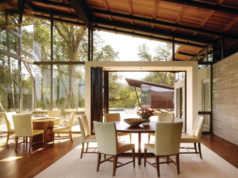 The dining area opens onto a pool deck shared by the central pavilion and two guest pavilions.