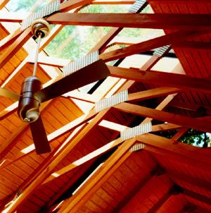 Every detail in this screened porch is exposed, including the steel connectors designed by architect Mark McInturff to hold the many 2x4s in place. Grooves cut into sheets of plywood add texture and interest to the ceiling.