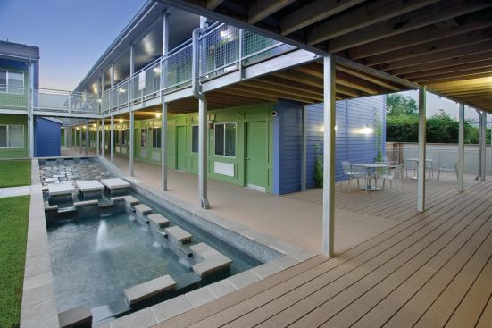 Outdoor spaces, including a fountain and outdoor cooking area, offer residents opportunities to gather as a community.