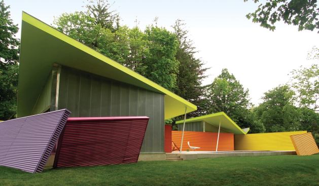 Stamberg Aferiat Architecture used painted corrugated aluminum for the canted accessory walls and multipaneled polycarbonate for the building's walls. A rubber butterfly roof tops the structure.