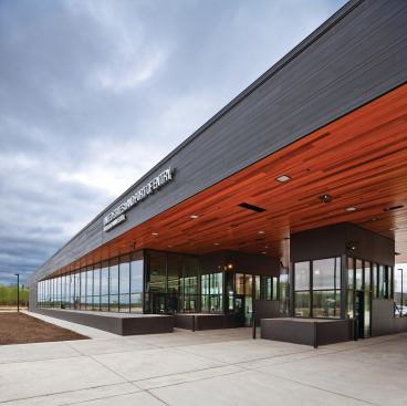 The exterior cedar siding is finished in a black stain, while the underside of exterior canopies and the interior ceilings of public and office space are finished in a natural stain.