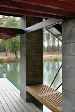 The standing-seam metal roof and built-in wooden benches (right) make the project a perfect place for lazing away a hot summer day.