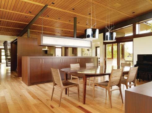 The kitchen is open to its surrounding areas, but millwork is used to organize the space and to keep cooking duties separate from the dining and living areas.

