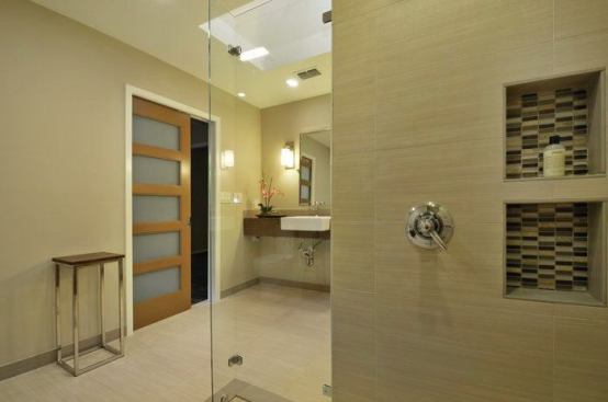 Niche shelves are positioned at each shower head, for both standing and sitting access. 