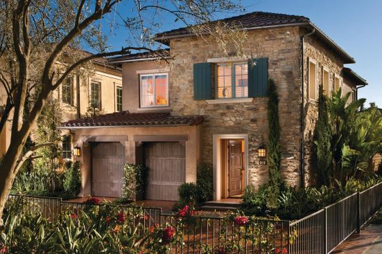 The Laguna Altura’s garage-dominated front is softened by stone and wooden garage doors and creates a bit of a mystery about the BALA Platinum award winner.