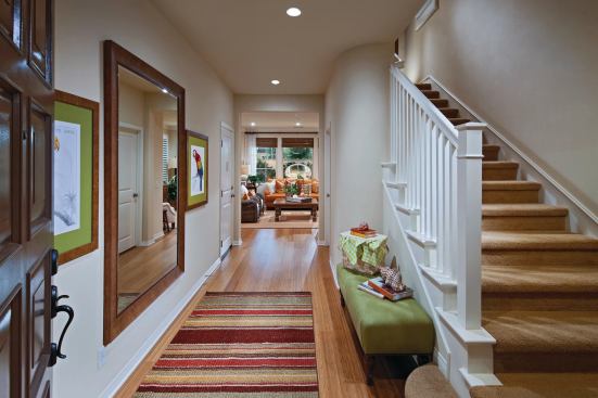 A hallway leads from the front door to the family great room haven.