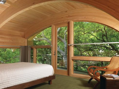 Moderated Modern The homes bold architecture makes a modern statement that is tempered by warm wood paneling.