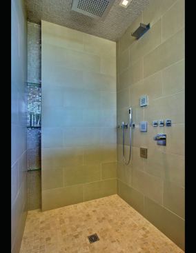 Niche shelves in the shower provide space for bath items. 