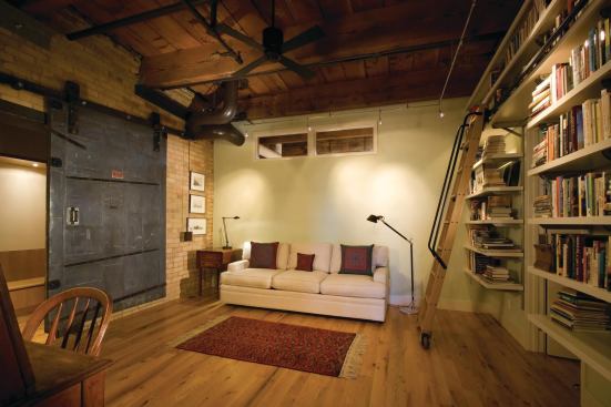 The study’s high windows borrow light from an atrium outside the unit.