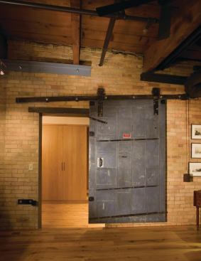 The tin-clad sliding door, which the owner found, likely came from a building of similar vintage.