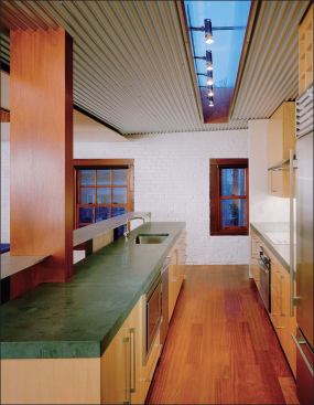 An unusually thick 2-inch slab of Burlington stone was speced for the countertops as a counterweight to the thin plane of aluminum perched above it (top).