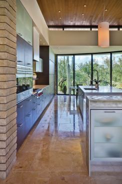 A wood ceiling reinforces the home's inside-outside connections while warming up the sleek, modern surroundings. 