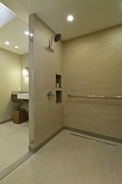 Grab bars are set throughout the bathroom. 
