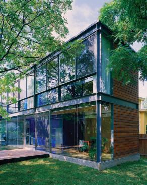 The house is constructed of a modular steel frame and prefab thermasteel panels to minimize construction waste. The exposed structure shows the construction process and defines the elevations.