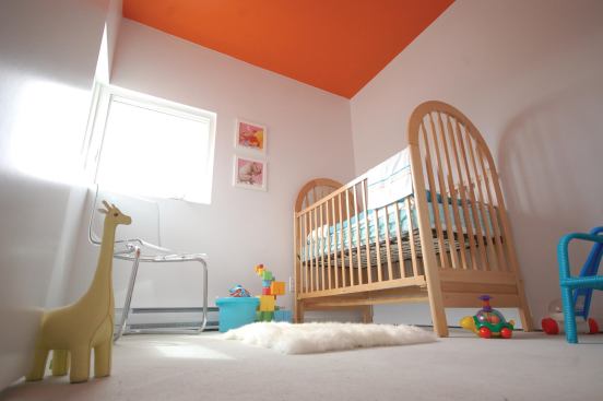 The orange color is used on interior ceilings and extended outside via custom-welded aluminum window cowlings.