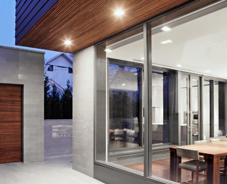 Storefront glazing floods the home wtih natural light.