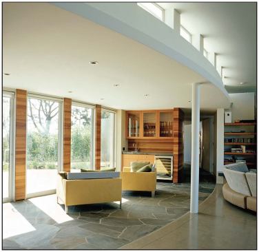 As with many of the firm’s houses, the quiet front elevation of this La Jolla, Calif., residence (below, left) gives way to a dramatic rear façade (left and below). Clerestory windows let sunlight spill into the interiors.