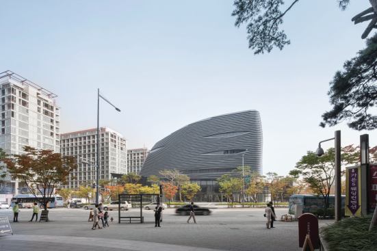 The rounded form of the upper volume is clad in louvers to mask imperfections in the construction of the metal skin.