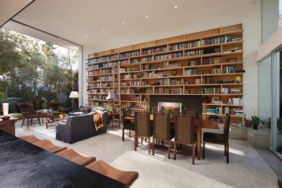 In addition to an eclectic collection of art and furniture, space was needed for the owner’s books. The living room floor looks like a rug, but it’s a smooth pebble aggregate that feels great on the feet. The room opens onto the front courtyard on one side.In addition to an eclectic collection of art and furniture, space was needed for the owner’s books. The living room floor looks like a rug, but it’s a smooth pebble aggregate that feels great on the feet. The room opens onto the front courtyard on one side.