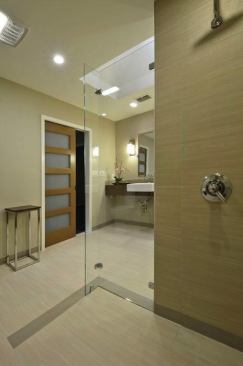 In the curbless shower, the tile runs in the direction of a large drain, facilitating water capture. 