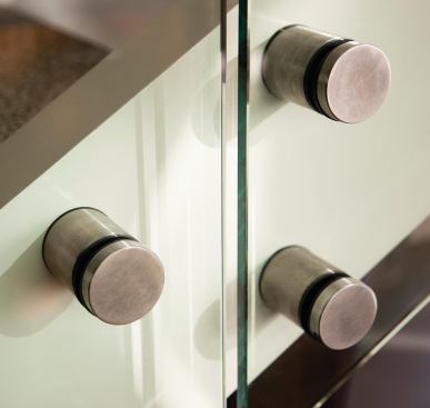 Bolts on the stair stand out as modern accents, a contrast to the soapstone and wood cabinetry in the media room.  