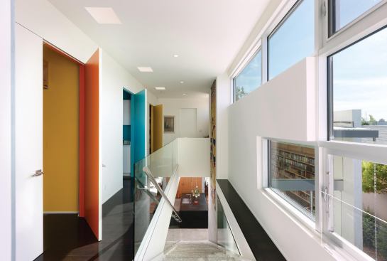 The owner wanted color in her house but didn’t want to push against the neutral palette of the architectural materials. Her great solution: color inside the laundry room and closet doors. 
