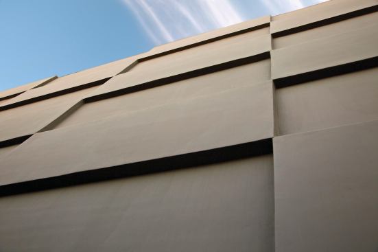 Crisp yet playful, the home’s north-facing façade is a shadowplay of rectangles in recess and relief.