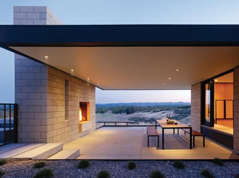 At the Paso Robles Residence, deep overhangs, outdoor rooms, strategically placed windows, and thick masonry walls provide natural temperature control.