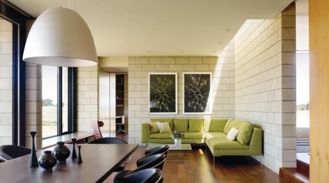 The home's masonry walls continue on the interior, their hue and texture evoking the surrounding landscape.