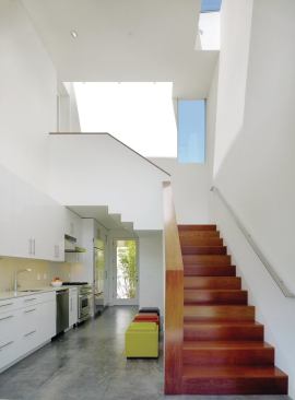 The guesthouse is technically a separate single-family home with its own kitchen. It was built to comply with city code and thus has its own garage. However, Erhlich uses the garage as a storage space. 

The driveway is a lawn.