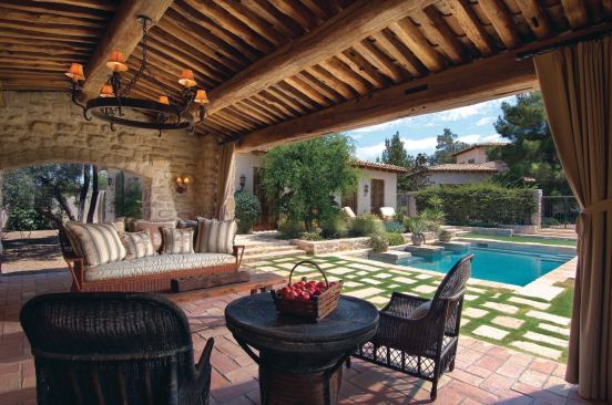 A roof framed with reclaimed beams shelters a poolside sitting area.

Architect: OZ Architects, Scottsdale, Ariz.; 

Interior designer: Karen Rapp Interiors, Phoenix

