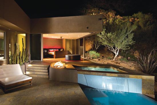 This modern house features motorized sliding doors that opens a corner of the master bedroom to the pool area.

Architect: Christy & Co., Scottsdale, Ariz.

