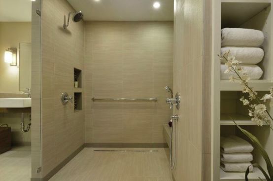 The shower has two heads; one for sit-down and one for wheelchair access. 