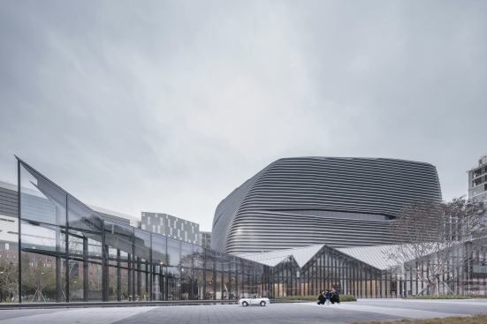The gallery has to do more than showcase model apartments, it also serves as a civic structure, with a plaza to attract area residents. 