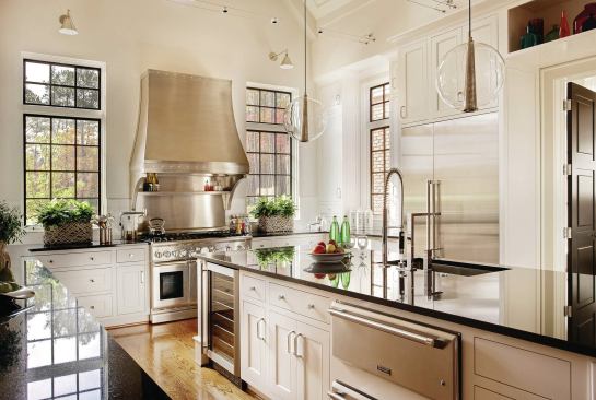 The kitchen is an entertainer's dream, with a soaring ceiling and tall windows that let in plenty of natural light. 