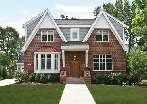 Exterior features--brick and cedar on the facade, lanterns, stone piers, and steep gables--help the Warren Residence fit into its old neighborhood.