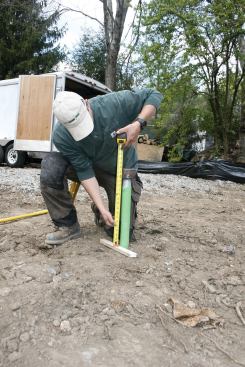 The height of the pile above grade is measured.