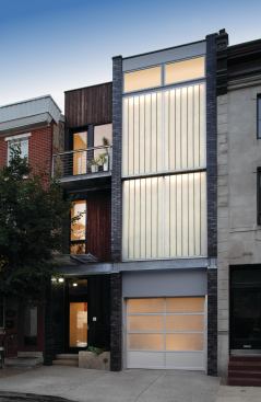 Richard and Kimberly Miller renovated a former Philadelphia stable into their own residence, pairing salvaged yellow pine with Kalwall on the front elevation. 