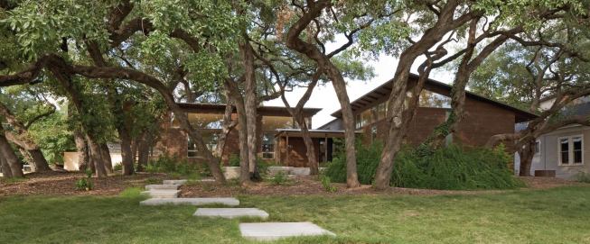 Siting of Hacienda Ja Ja protected the existing live oak trees, while drought-tolerant plantings, native buffalograss, and permeable walkways reduce landscape water needs supplied by the 6,000-gallon rainwater catchment system. 