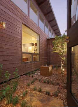 The compact floor plan is laid out around this small central courtyard, maximizing cross ventilation and natural lighting for the adjacent spaces. 